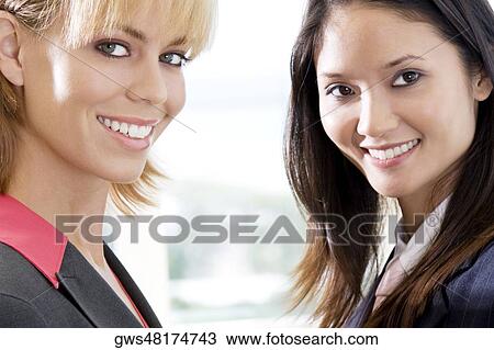 Portrait of two businesswomen smiling View Large Photo Image Stock Image - Portrait of two businesswomen smiling. Fotosearch