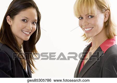 Portrait of two businesswomen smiling View Large Photo Image Stock Photograph - Portrait of two businesswomen smiling. Fotosearch