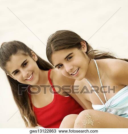 Stock Image - Portrait of two teenage girls sitting together. Fotosearch