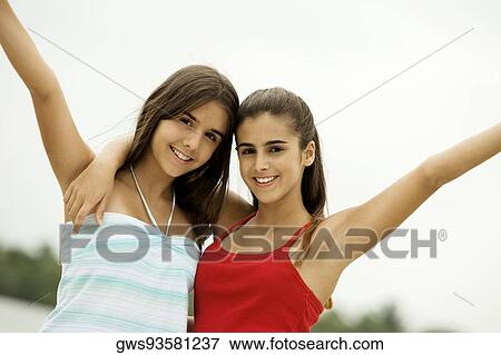 Portrait of two teenage girls with their arms around each other View Large Photo Image Stock Photo - Portrait of two teenage girls with their arms around each other. Fotosearch