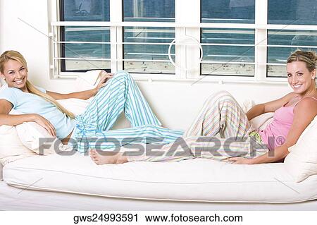 Stock Image - Portrait of two young women smiling. Fotosearch