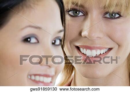 Portrait of two young women smiling View Large Photo Image Stock Image - Portrait of two young women smiling. Fotosearch
