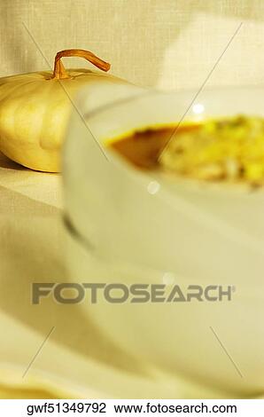 Pumpkin near a bowl of vegetable soup View Large Photo Image Stock Image - Pumpkin near a bowl of vegetable soup. Fotosearch