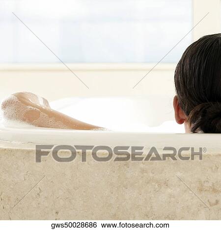 Rear view of a woman in the bathtub View Large Photo Image Stock Photograph - Rear view of a woman in the bathtub. Fotosearch