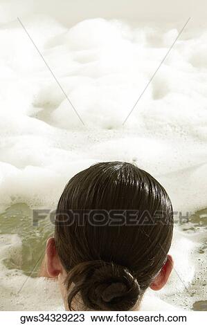 Rear view of a young woman in a bathtub View Large Photo Image Stock Image - Rear view of a young woman in a bathtub. Fotosearch