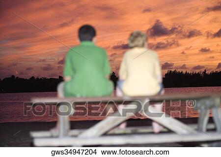 Rear view of two boys sitting on a picnic table View Large Photo Image Picture - Rear view of two boys sitting on a picnic table. Fotosearch
