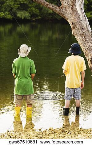 Rear view of two teenage boys fishing in a lake View Large Photo Image Stock Image - Rear view of two teenage boys fishing in a lake. Fotosearch