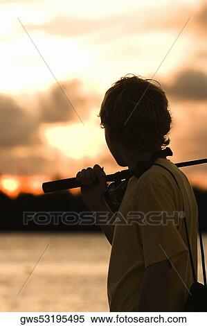 Side profile of a boy carrying a fishing rod View Large Photo Image Stock Photography - Side profile of a boy carrying a fishing rod. Fotosearch