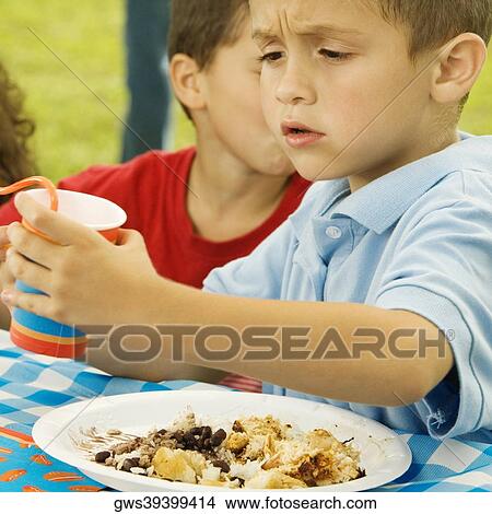 Side profile of a boy holding a disposable cup View Large Photo Image Picture - Side profile of a boy holding a disposable cup. Fotosearch