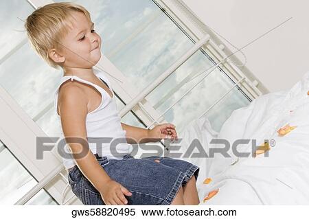 Side profile of a boy jumping on the bed View Large Photo Image Stock Photography - Side profile of a boy jumping on the bed. Fotosearch