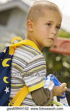 Side profile of a boy looking serious View Large Photo Image Stock Image - Side profile of a boy looking serious. Fotosearch