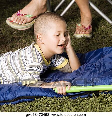 Side profile of a boy lying on a sleeping bag View Large Photo Image Stock Photo - Side profile of a boy lying on a sleeping bag. Fotosearch