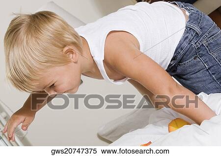 Side profile of a boy playing on the bed View Large Photo Image Stock Photography - Side profile of a boy playing on the bed. Fotosearch