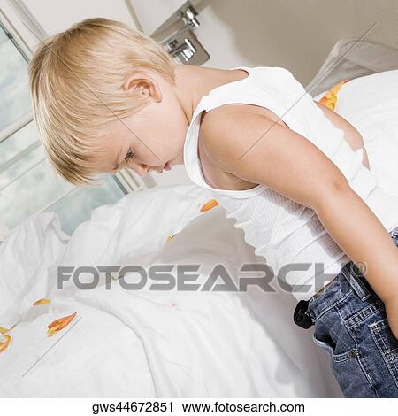 Side profile of a boy standing near the bed View Large Photo Image Stock Image - Side profile of a boy standing near the bed. Fotosearch