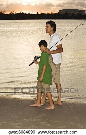 Side profile of a boy walking with his father on the beach View Large Photo Image Stock Photo - Side profile of a boy walking with his father on the beach. Fotosearch