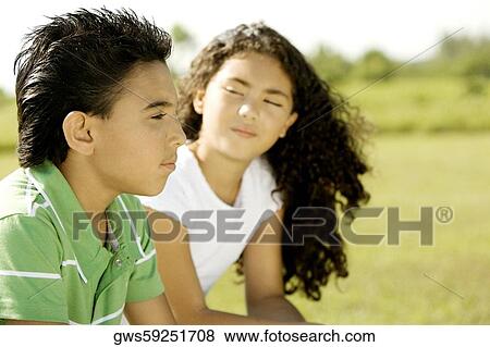 Side profile of a brother and his sister sitting together View Large Photo Image Stock Photo - Side profile of a brother and his sister sitting together. Fotosearch