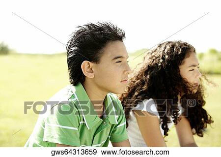Side profile of a brother and his sister sitting together View Large Photo Image Stock Photo - Side profile of a brother and his sister sitting together. Fotosearch