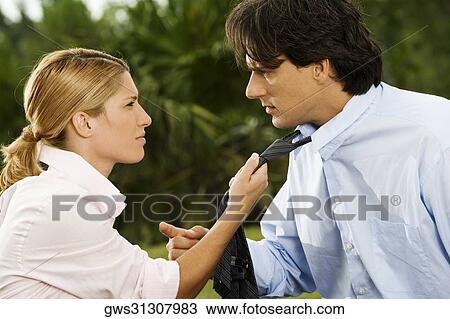 Side profile of a businesswoman holding a businessman's tie View Large Photo Image Stock Image - Side profile of a businesswoman holding a businessman's tie. Fotosearch