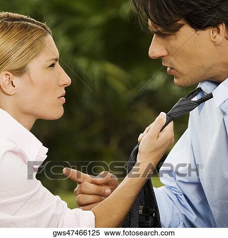Side profile of a businesswoman holding a businessman's tie View Large Photo Image Stock Photography - Side profile of a businesswoman holding a businessman's tie. Fotosearch