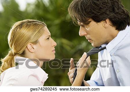 Side profile of a businesswoman holding a businessman's tie View Large Photo Image Stock Photography - Side profile of a businesswoman holding a businessman's tie. Fotosearch
