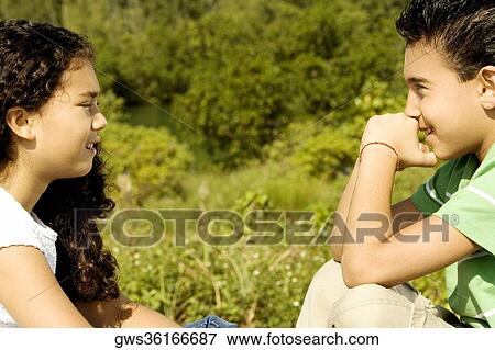 Side profile of a girl and a boy smiling View Large Photo Image Stock Photo - Side profile of a girl and a boy smiling. Fotosearch