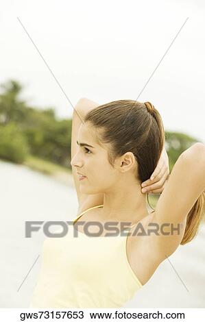 Side profile of a girl holding her hair View Large Photo Image Stock Image - Side profile of a girl holding her hair. Fotosearch