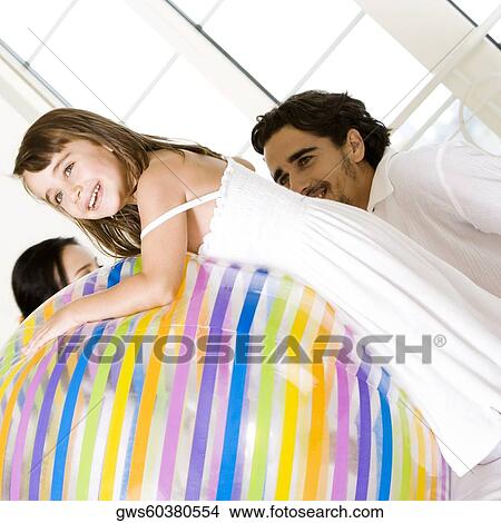 Side profile of a girl leaning over a large ball View Large Photo Image Picture - Side profile of a girl leaning over a large ball. Fotosearch