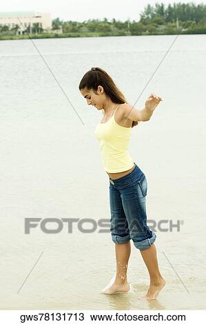 Side profile of a girl standing on the beach View Large Photo Image Stock Image - Side profile of a girl standing on the beach. Fotosearch