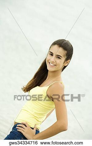 Side profile of a girl standing with her hand on her hip View Large Photo Image Stock Photograph - Side profile of a girl standing with her hand on her hip. Fotosearch
