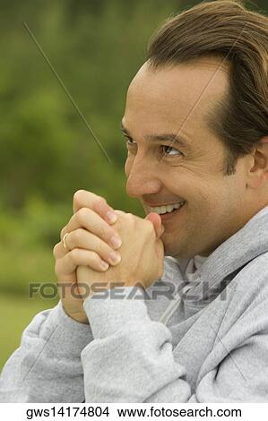 Side profile of a mature man with his hands clasped View Large Photo Image Picture - Side profile of a mature man with his hands clasped. Fotosearch