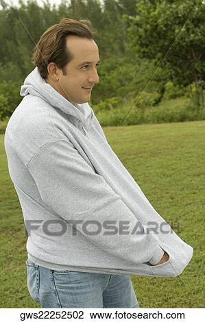 Side profile of a mature man with his hands in his pockets View Large Photo Image Stock Image - Side profile of a mature man with his hands in his pockets. Fotosearch