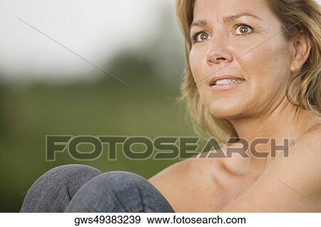 Side profile of a mature woman hugging her knees View Large Photo Image Stock Photo - Side profile of a mature woman hugging her knees. Fotosearch