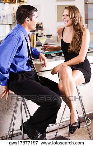 Side profile of a mid adult man and a young woman at a bar counter View Large Photo Image Stock Photo - Side profile of a mid adult man and a young woman at a bar counter. Fotosearch