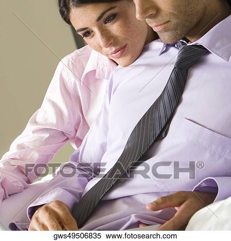 Side profile of a mid adult man and a young woman sitting on a couch View Large Photo Image Stock Photography - Side profile of a mid adult man and a young woman sitting on a couch. Fotosearch