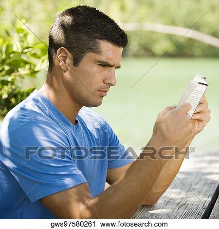 Side profile of a mid adult man reading a book View Large Photo Image Stock Image - Side profile of a mid adult man reading a book. Fotosearch