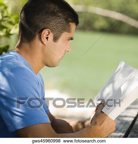 Side profile of a mid adult man reading a book View Large Photo Image Stock Photo - Side profile of a mid adult man reading a book. Fotosearch