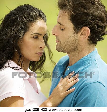 Side profile of a mid adult man embracing a young woman View Large Photo Image Stock Image - Side profile of a mid adult man embracing a young woman. Fotosearch