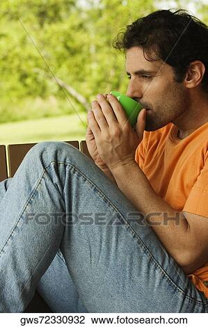 Side profile of a mid adult man drinking from a mug View Large Photo Image Stock Image - Side profile of a mid adult man drinking from a mug. Fotosearch