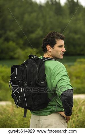 Side profile of a mid adult man standing with his hand on his hip View Large Photo Image Stock Photo - Side profile of a mid adult man standing with his hand on his hip. Fotosearch