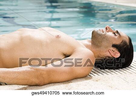 Side profile of a mid adult man sunbathing at the poolside View Large Photo Image Stock Photography - Side profile of a mid adult man sunbathing at the poolside. Fotosearch