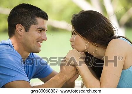 Side profile of a mid adult man with a young woman holding hands View Large Photo Image Stock Photo - Side profile of a mid adult man with a young woman holding hands. Fotosearch