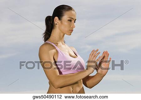 Side profile of a mid adult woman exercising View Large Photo Image Stock Image - Side profile of a mid adult woman exercising. Fotosearch