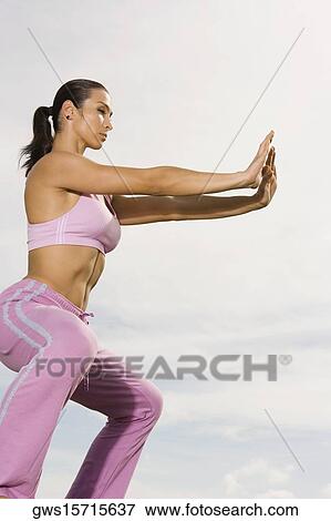 Side profile of a mid adult woman practicing martial arts View Large Photo Image Stock Photo - Side profile of a mid adult woman practicing martial arts. Fotosearch
