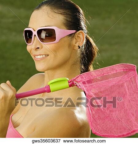 Side profile of a mid adult woman holding a butterfly net View Large Photo Image Stock Photo - Side profile of a mid adult woman holding a butterfly net. Fotosearch