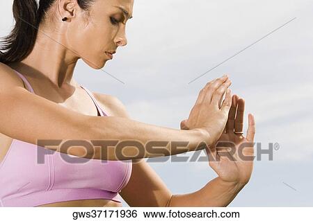Side profile of a mid adult woman practicing martial arts View Large Photo Image Stock Photograph - Side profile of a mid adult woman practicing martial arts. Fotosearch