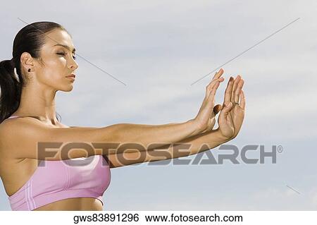 Side profile of a mid adult woman exercising View Large Photo Image Stock Photograph - Side profile of a mid adult woman exercising. Fotosearch
