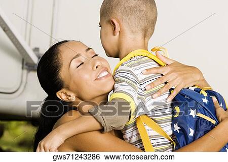 Side profile of a mother hugging her son View Large Photo Image Stock Photograph - Side profile of a mother hugging her son. Fotosearch