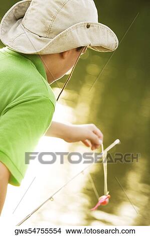 Side profile of a teenage boy fishing in a lake View Large Photo Image Picture - Side profile of a teenage boy fishing in a lake. Fotosearch