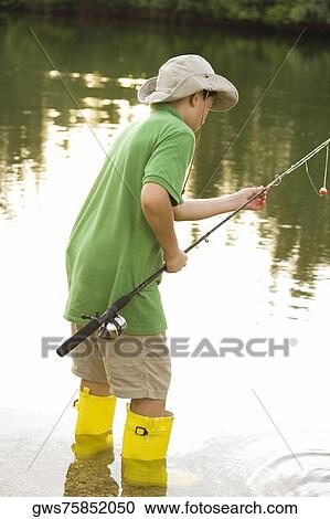 Side profile of a teenage boy holding a fishing rod View Large Photo Image Stock Image - Side profile of a teenage boy holding a fishing rod. Fotosearch