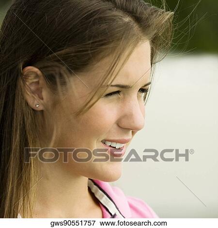 Side profile of a teenage girl smiling View Large Photo Image Stock Photo - Side profile of a teenage girl smiling. Fotosearch